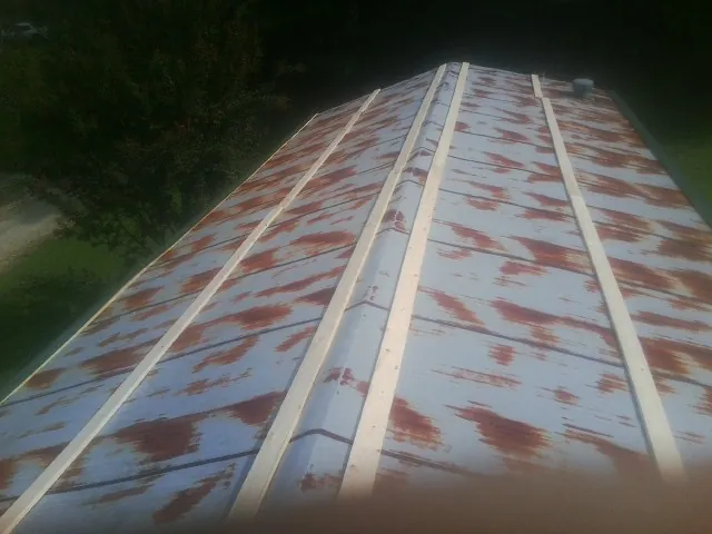 Rusted metal roof panels with new wood purlins before replacement — Storm Damage Roof Repair in Wimberley by Roofing Brothers